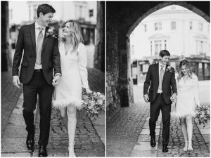 Black and White Photo of Oliver & Abigail walking down the street in Intimate Wedding at Winchester Registry Office