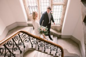 Elegant Couple walking down the stairs at Winchester Registry Office