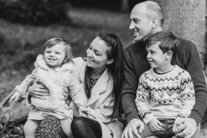 Family Photography - black and white photo of family smiling and looking at eahcother