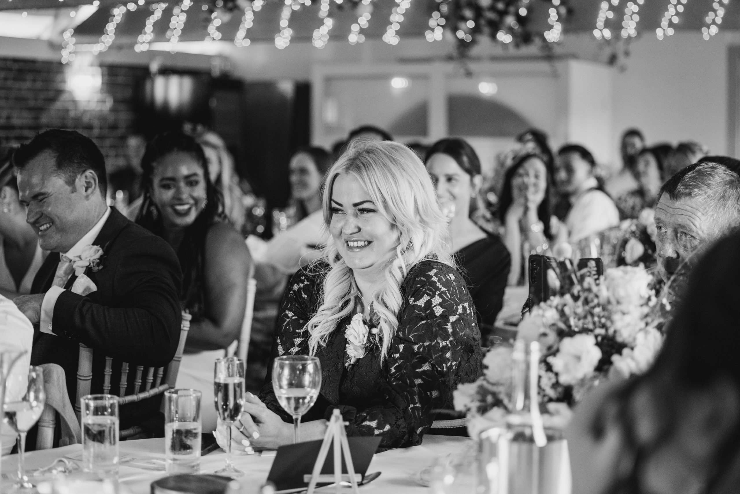 wedding guest smiling at the speeches