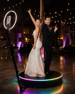 360 photo booth in Hampshire -Bride and groom posing on the 360 booth platform